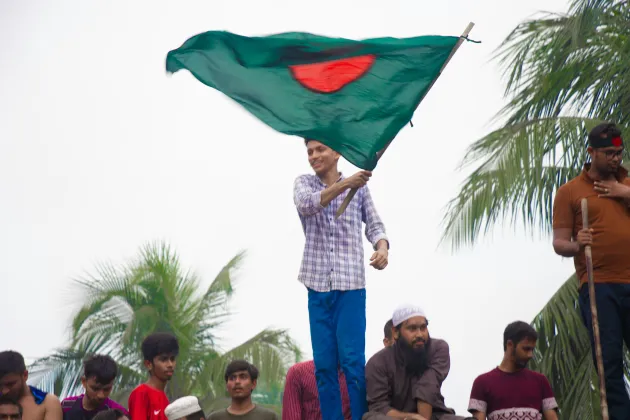 Happy boy holding the Bangladesh flag. Photo.